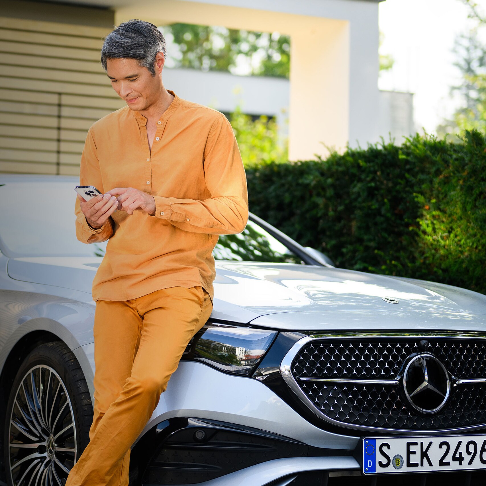 Man and woman walking towards white Mercedes-Benz EQS
