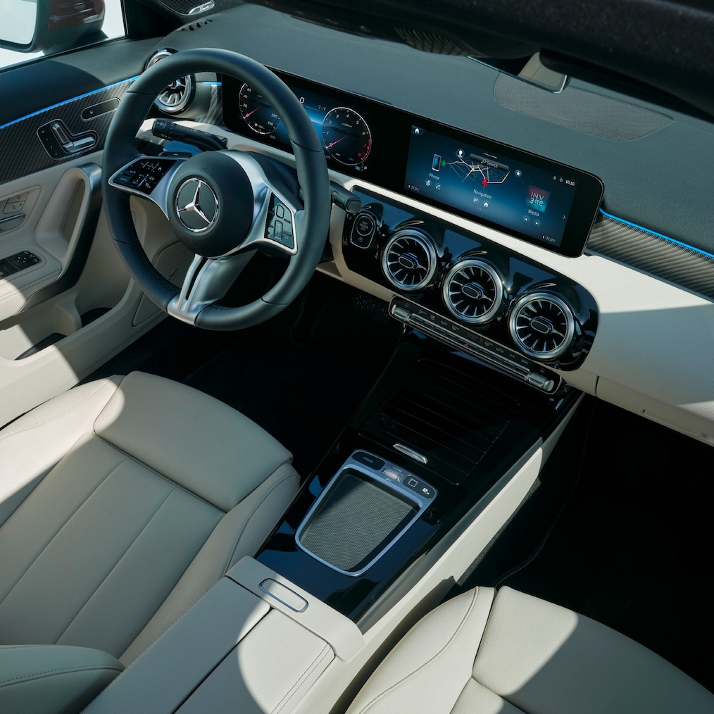 Dynamic view of a Mercedes-Benz C-Class Saloon (driving shot) or standing at a charging station.